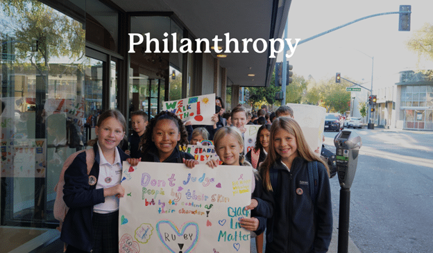 philanthropy - students holding up poster boards regarding social issues